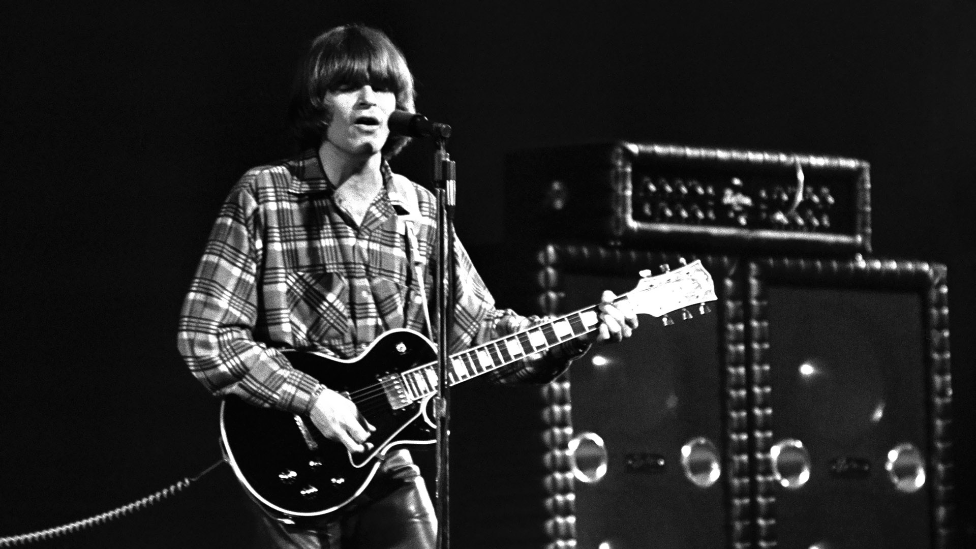John Fogerty's "I Saw It On T.V." from the 1985 album Centerfield as a solo acoustic-driven reflection on American historical milestones