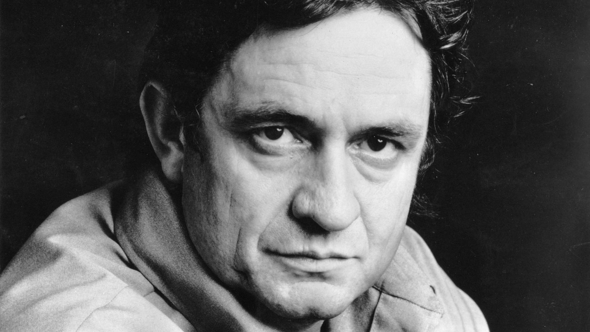 Johnny Cash captured a raw, rhythmic sound with his 1956 Sun Records classic 'I Walk the Line,' which became his first number one country hit.
